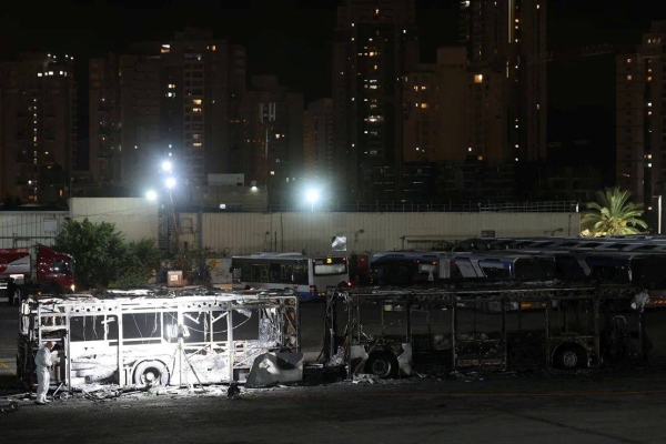 Forensic personnel inspects the area where a bus exploded, in Bat Yam, south of Tel Aviv, Israel