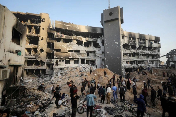 Palestinians inspect the destruction wrought by an Israeli military raid at Al-Shifa Hospital, northern Gaza, in April