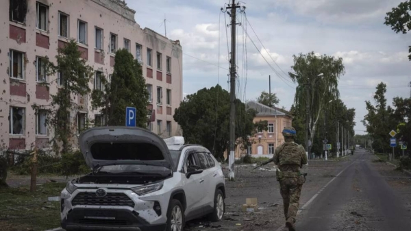 A Ukrainian soldier walks past a building in Sudzha, Kursk region, Russia