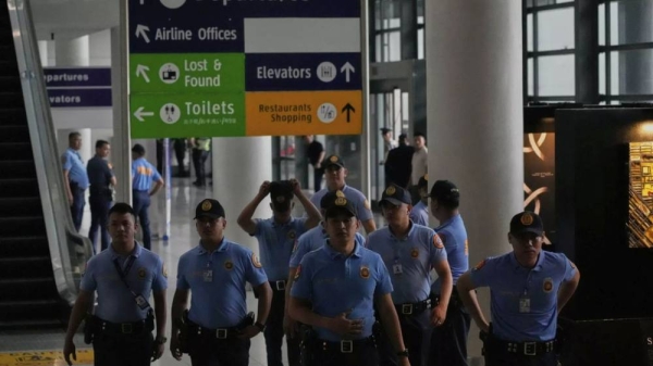 Security officers patrol the airport after former President Rodrigo Duterte was arrested, in Manila, Philippines, Tuesday, March 11, 2025