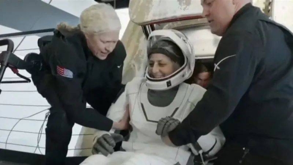 Triumphant — Suni Williams exits the capsule