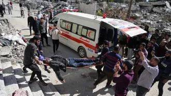 Palestinians evacuate an injured man after his house was hit by an Israeli bombardment in Gaza City