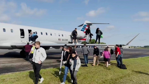 Passengers on an American Airlines regional jet evacuated on the runway, Tuesday, after experiencing, what they describe, as a burning smell and light smoke inside the cabin