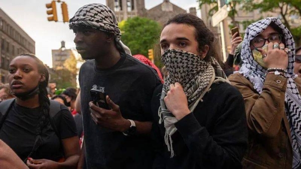Crowds of protesters grew as a standoff with security and a group calling themselves 'Columbia University Apartheid Divest' at the library continued into the evening