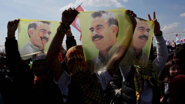 Supporters of pro-Kurdish Peoples' Equality and Democracy Party display flags with a portrait of jailed Kurdistan Workers Party leader Abdullah Ocalan during a rally in Istanbul, Turkey, in March 2024