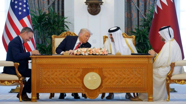 US President Donald Trump, Qatar's Emir Tamim bin Hamad Al Thani and Boeing CEO Kelly Ortberg attend a signing ceremony in Doha, Qatar on May 14, 2025