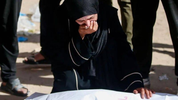 A mourner reacts during the funeral of Palestinians killed in Israeli strikes at the Indonesian hospital in Beit Lahia