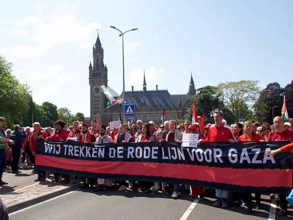 Protesters carry a banner that reads We trekken een rode lijn voor Gaza (We draw a red line for Gaza) during the Red Line protest in The Hague, Netherlands on 18 May, 2025