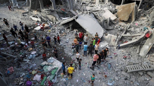 Palestinians inspect the site of an Israeli strike in Jabalya, northern Gaza, on May 18, 2025