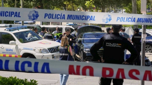 Police officers cordon off the area outside The American School of Madrid shortly after the former senior aide to ex-Ukrainian president Viktor Yanukovych was shot