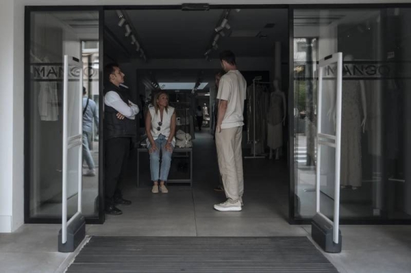 Shop employees wait during an electricity outage in Cannes, southern France on Saturday. (AP Photo)