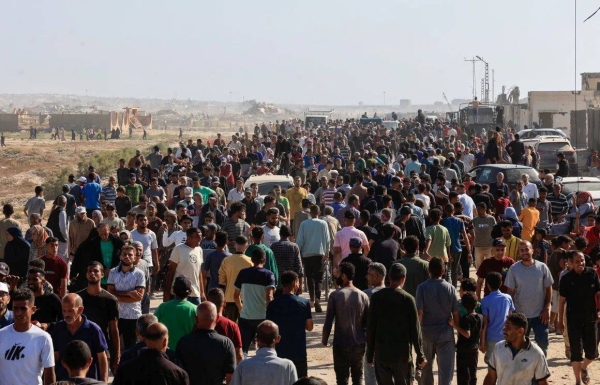 Palestinians gather near an aid distribution site run by the US-backed Gaza Humanitarian Foundation in Rafah, Gaza, on Tuesday