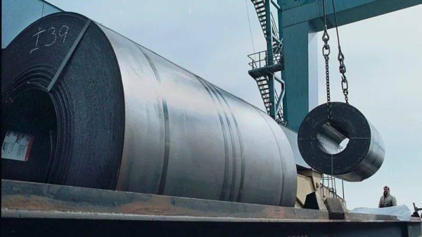 Workers use a crane to load a 60,000 pound coil of steel from Holland onto a railroad car for shipment to Ford Motor Company in Ohio from a warehouse at the South Jersey Port Corporation, March 6, 2002 in Camden, NJ along the 
