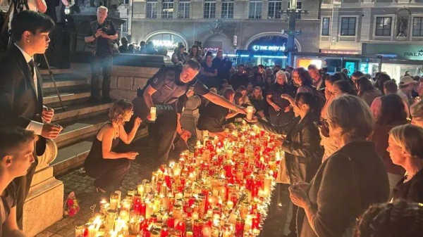 Tearful Graz residents light candles at Austrian school shooting vigil