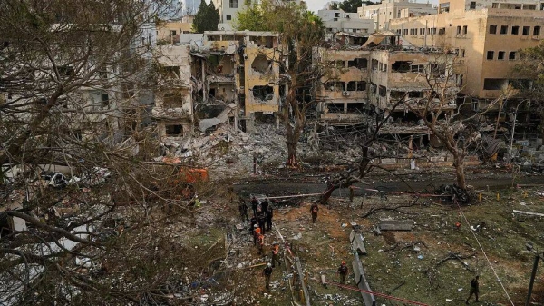 Rescue teams work at the site where a missile launched from Iran struck Tel Aviv, Israel, Monday, June 16, 2025