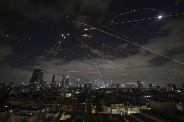 The Israeli Iron Dome air defense system fires to intercept missiles during an Iranian attack over Tel Aviv, Israel, on Sunday.