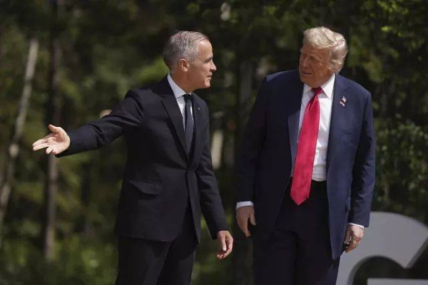 Canada Prime Minister Mark Carney, left, gestures as he welcomes President Donald Trump during the G7 Summit in Kananaskis, Alberta, Canada, Monday, June 16, 2025