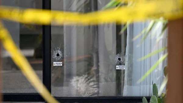 Images of the villa show bullet holes in the windows and blood stains on the floor