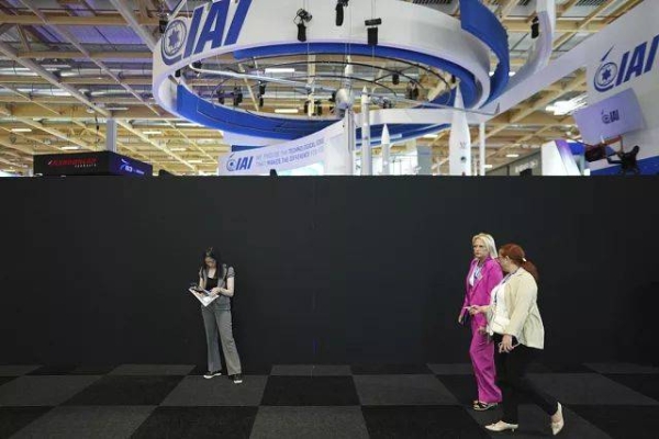 Visitors walk by the Israeli pavilions blocked by a black wall at the Paris Air Show Tuesday, June 17, 2025 in Le Bourget, north of Paris