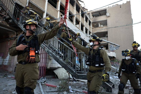 First responders work at the scene of an Iranian strike in Haifa, Israel, on Friday.