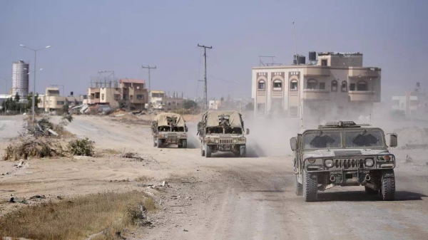 Israeli army vehicles transport a group of soldiers and journalists inside the southern Gaza Strip. (File photo)