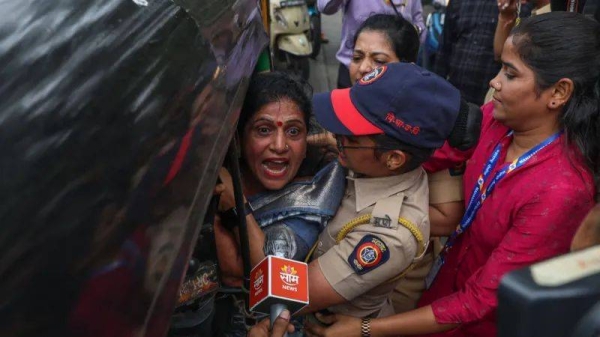 Police in Mumbai detain a woman who was participating in a protest this week against alleged injustice to Marathi speakers