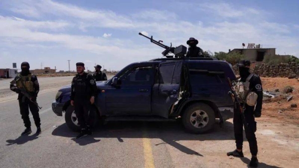 Members of Syrian security forces stand guard following clashes in Sweida province in May