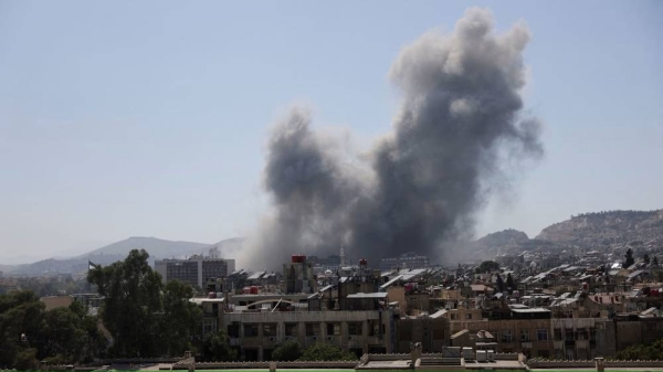 Smoke rises after strikes on Syria's defense ministry in Damascus on Wednesday