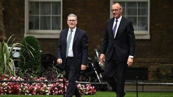 German Chancellor Friedrich Merz, right walks with Britain's Prime Minister Keir Starmer ahead of their meeting at 10 Downing Street in London, Thursday, July 17, 2025