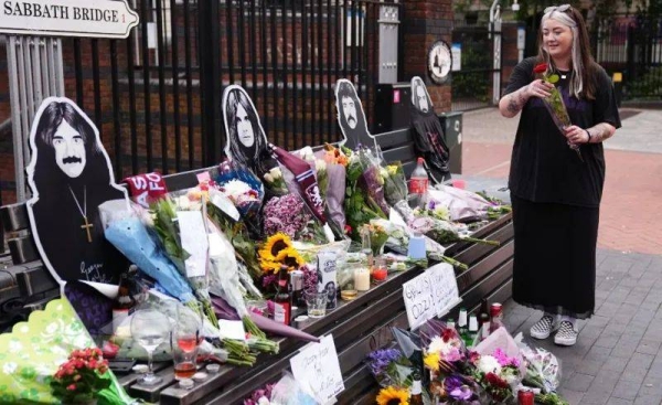 Fans left flowers, candles, handwritten notes and memorabilia on the Black Sabbath Bridge bench in Birmingham
