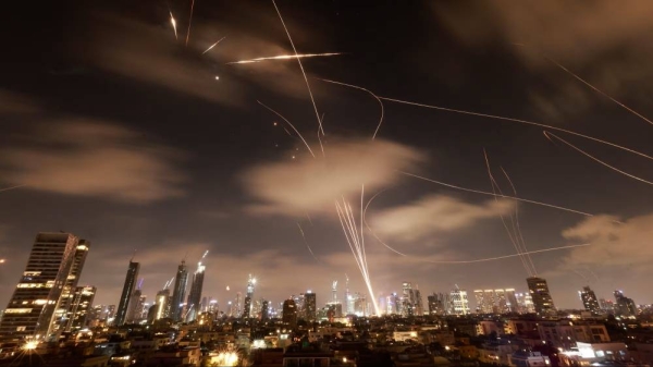 Israeli air defence systems are activated to intercept Iranian missiles over the Israeli city of Tel Aviv early on June 18, 2025, during the 12-day Israel-Iran war.
