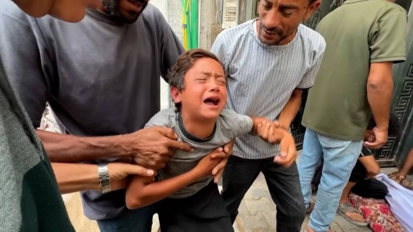 A boy cries after his father was killed near an aid site in Gaza