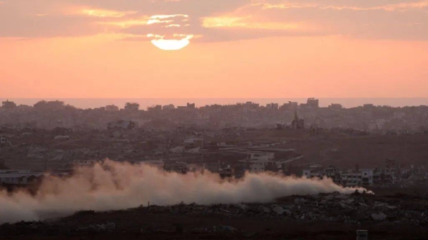 Smoke rises from Gaza as the sun sets, as seen from the Israeli side of the Israel-Gaza border, July 30