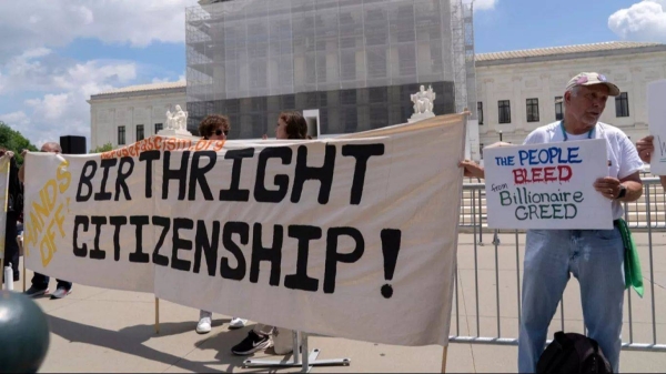 Demonstrators holds up a banner during a citizenship rally outside of the Supreme Court in Washington, May 15, 2025