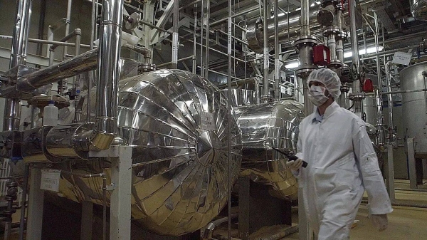 An Iranian security official in protective clothing walks through part of the Uranium Conversion Facility just outside the city of Isfahan, 30 March, 2005
