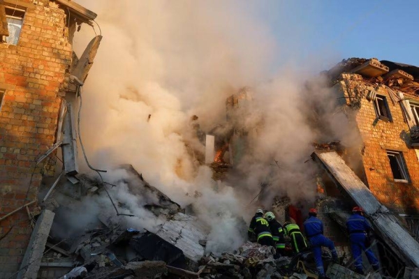 Rescuers work at the site of a building which was hit by a Russian missile and drone strike in Kyiv, Ukraine, on Thursday, August 28