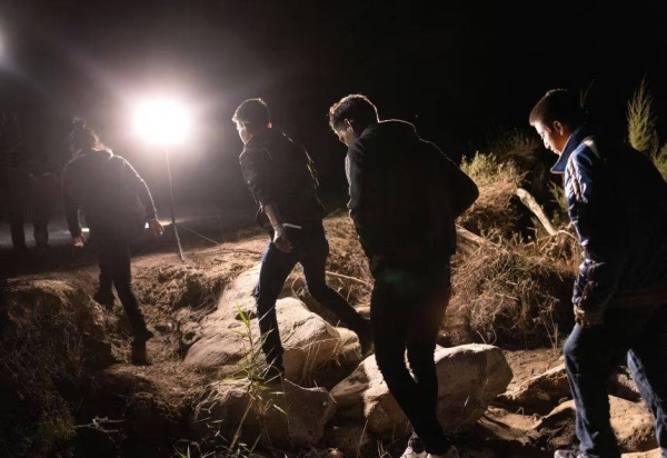 Unaccompanied minors walk up bank of the Rio Grande after crossing the U.S.-Mexico border early on April 30, 2021 in Roma, Texas