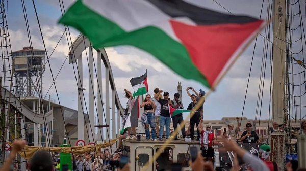 Activists wave on a boat taking part in a civilian flotilla bound for Gaza in Barcelona, 31 August, 2025