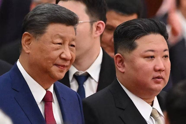 Chinese leader Xi Jinping and North Korean leader Kim Jong Un arrive for a reception in the Great Hall of People, following a military parade marking the 80th anniversary of the end of World War II, in Beijing on September 3, 2025