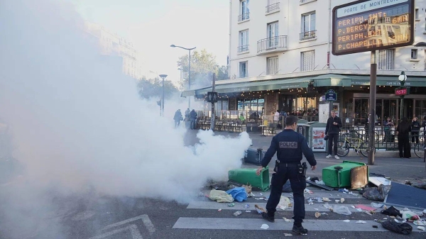 A police officer stands next to bins placed on a street to block it during the Bloquons Tout (Block Everything) protest movement in Paris, 10 September 2025