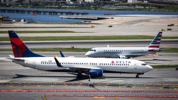 Delta Airlines and American Airlines planes taxi at LaGuardia Airport in Queens, New York