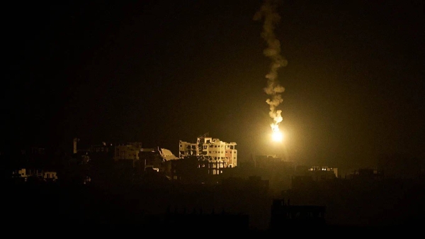 An Israeli army flare drifts over buildings during the Israeli ground and air operations in the northern Gaza Strip, as seen from southern Israel, Monday, Sept. 15, 2025