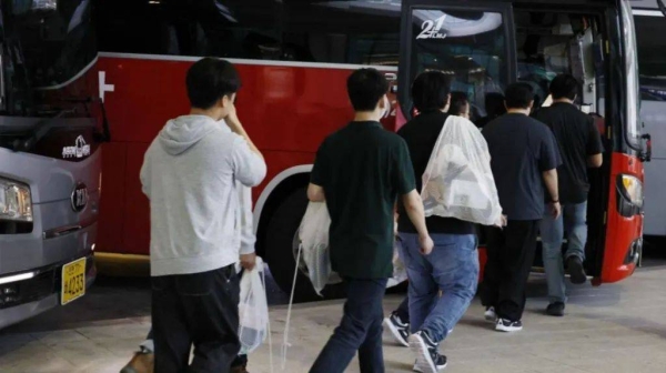 The South Korean workers, seen here boarding buses at Incheon airport, were repatriated last Friday