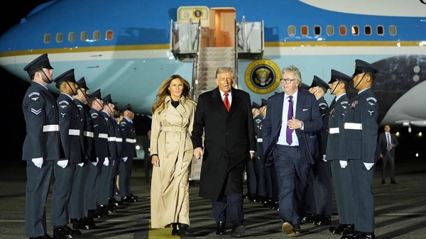 President Donald Trump and first lady Melania Trump are greeted by The Viscount Hood, Lord-in-Waiting, center, right, as they arrive at Stansted Airport near London, Tuesday