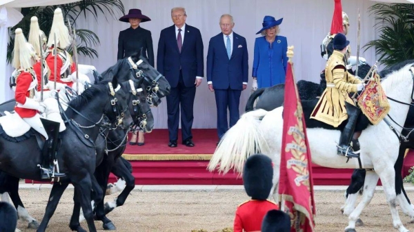President Trump, Melania Trump, the King and Queen Camilla watching a military parade in Windsor Castle