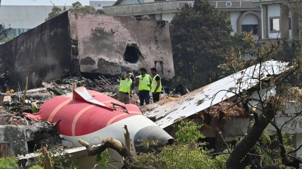 The aftermath of the Air India crash showing a part of the plane crashed in the ground