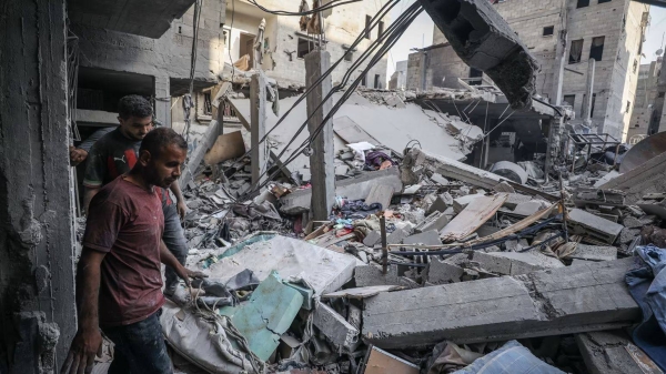 Residents inspect the rubble of destroyed buildings following an Israeli attack on Al-Shati, or Beach, refugee camp in Gaza City on September 23