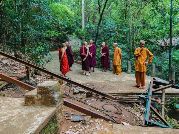 Buddhist monks stand at the site of a cable car accident in Sri Lanka on Thursday, September 25
