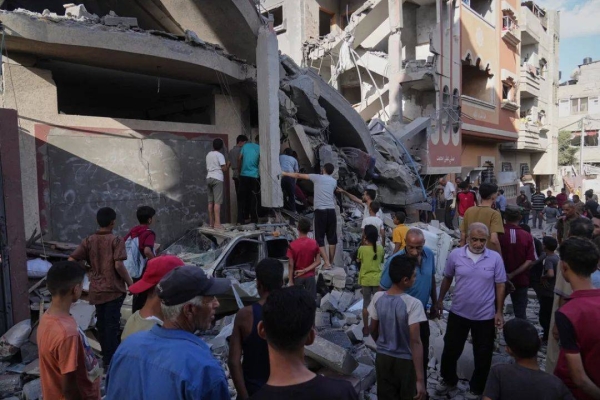 Palestinians survey the aftermath of an Israeli military strike on the Abu Dahrouj family home in Zawaida, central Gaza Strip, Thursday, Sept. 25, 2025